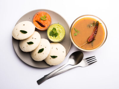Idly sambar or Idli with Sambhar and green, red chutney. Popular South indian breakfast